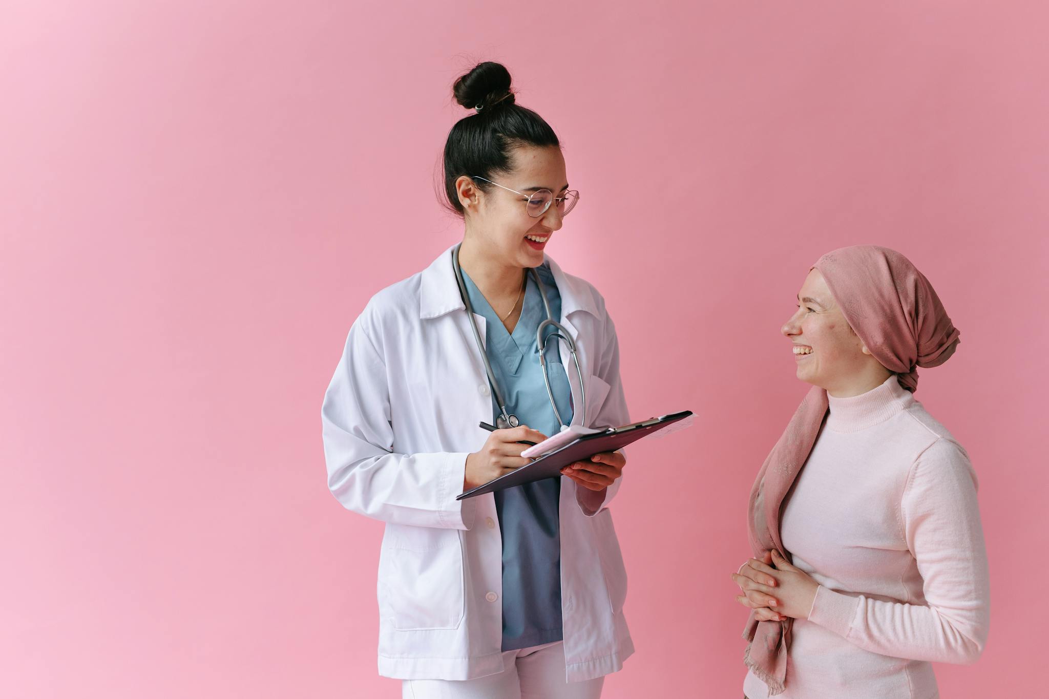 A doctor and cancer patient sharing a positive moment with empathy and care.