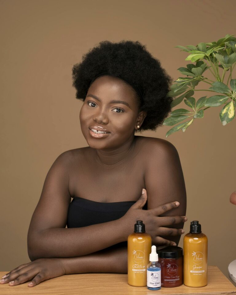Portrait of a woman with skincare products, studio setting.